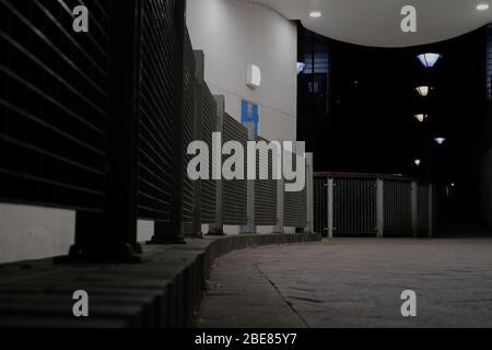 London, Großbritannien - 12. April 2020 - Blick von Grund auf den überdachten Gang bei Nacht Stockfoto