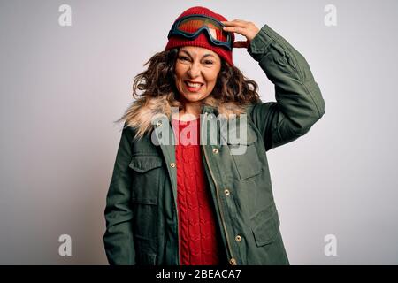 Mittlere Alter Skifahrer Frau trägt Schnee Sportbekleidung und Skibrille über weißem Hintergrund verwirren und fragen sich über Frage. Unsicher mit Zweifel, denkend Stockfoto