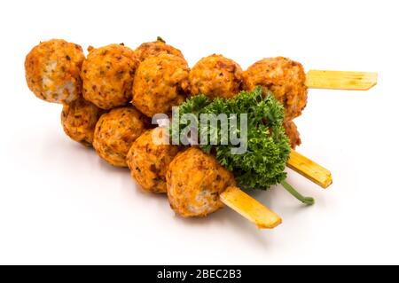 Marinierte Fleischbällchen Spieße auf einem Holzpflücken und einem weißen Hintergrund. Stockfoto