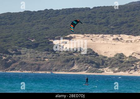 Tarifa, Spanien. Februar 2020. Kitesurfer im Atlantik in der Nähe des windigen Bolonia Strandes Stockfoto