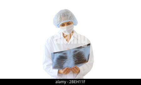 Ärztin trägt medizinische Maske Blick auf Röntgenbild auf whi Stockfoto
