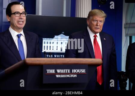 US-Präsident Donald J. Trump reagiert neben US-Finanzminister Steven T. Mnuchin auf die Pressekonferenz der Coronavirus Task Force im Weißen Haus in Washington am 13. April 2020. Kredit: Yuri Gripas/Pool über CNP/MediaPunch Stockfoto