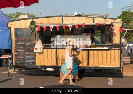 Darwin, Australien - 1. Juni 2019: Frau kauft mexikanisches Essen aus einem Straßenlebenswagen auf dem malakischen Bauernmarkt in Darwin. Lokales Konzept für kleine Unternehmen Stockfoto