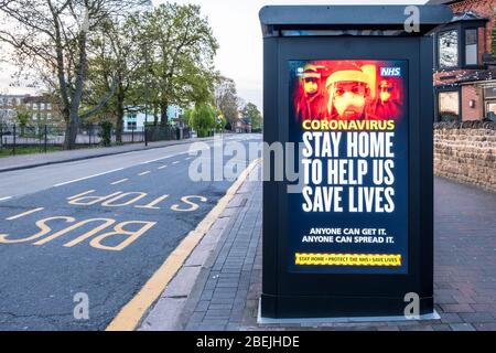 Coronavirus. Bleiben Sie zu Hause, um uns zu helfen, Leben zu retten. Covid-19 Lockdown-Nachricht auf einer Bushaltestelle in einer leeren Straße, Nottinghamshire, England, Großbritannien Stockfoto