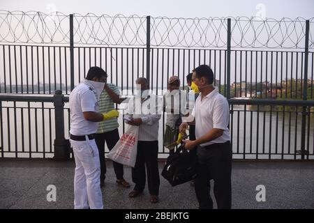 Kalkutta, Indien. April 2020. Ein Polizist überprüft die Informationen der Menschen während der landesweiten Sperrung in Kalkutta, Indien, 13. April 2020. Indiens Bundesgesundheitsministerium sagte am Dienstag Morgen, dass die Zahl der Todesopfer aufgrund der COVID-19 in Indien auf 339 gestiegen sei und die Gesamtzahl der bestätigten Fälle im Land 10,363 erreichte. Kredit: Str/Xinhua/Alamy Live News Stockfoto
