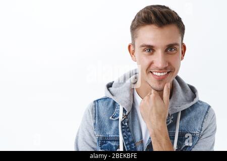 Nahaufnahme Porträt von neugierig, fasziniert schönen blonden Mann sehen gute Gelegenheit, berühren Kinn und lächeln interessiert, mit Idee, Think-up Plan Stockfoto