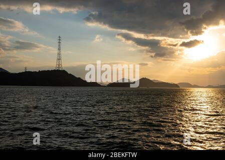 Sonnenuntergang in der Seto-Binnenmeer, Japan. Goldene Reflexion auf der Meeresoberfläche Stockfoto