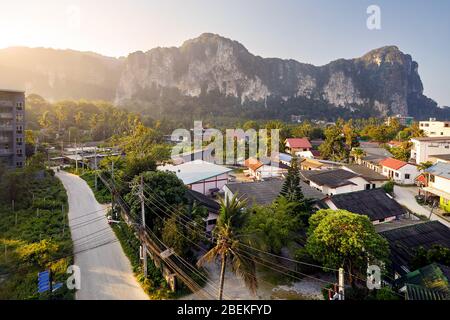 Ao Nang Tropical Village mit Hotel und kleine Häuser in Rock Mountain Hintergrund bei Sonnenaufgang in der Provinz Krabi, Thailand Stockfoto
