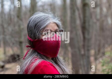 Karen Rentz modelliert eine ihrer selbstgemachten Stoffmasken mit einem Polypropylen-Ofenfiltereinsatz, um sich auf das Ausgehen in der Öffentlichkeit während der Covid-19 vorzubereiten Stockfoto