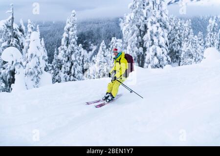 Frau im gelben Backcountry Skifahren in Squamish, BC, Paul's Ridge Stockfoto