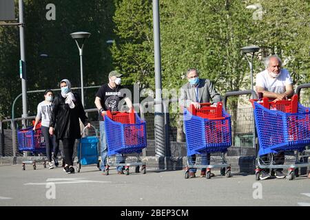 Coronavirus Pandemie Effekte: Lange Schlange, um den Supermarkt zum Einkaufen zu betreten. Mailand, Italien - April 2020 Stockfoto