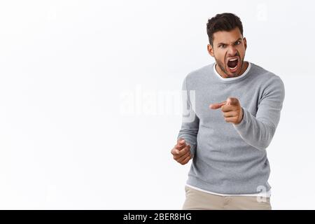 Empört stattlichen Mann mit schlechter Laune verlieren Kontrolle über Emotionen, verzweifelt zeigen Kamera und schreien Anschuldigungen, Schuld jemand in Wut und Stockfoto