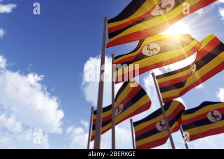 Ugandas Fahnen wehen im Wind gegen einen blauen Himmel. 3D-Rendering Stockfoto