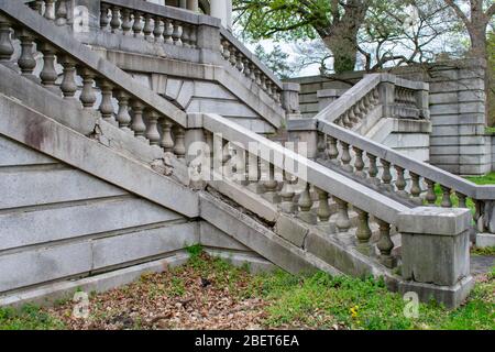 Eine detaillierte Reihe von Steinstufen, die zu einem Anwesen von einem Grass Courtyard mit einem Crack in der Seite führen Stockfoto