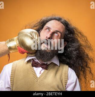 Skinny, seltsame Nerd mit einem Boxhandschuh gestanzt Stockfoto