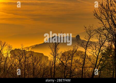 Unglaublicher Hazy Sonnenuntergang über den Silhouetten der seltsam geformten Sandsteinfelsen in der historischen Stadt Belogradchik, Nordwestbulgarien Stockfoto