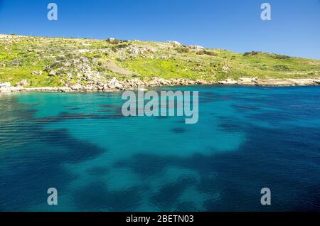 Lebhaftes blaues Wasser im Hafen in der Nähe der Stadt Mgarr auf Gozo Island, Malta Stockfoto