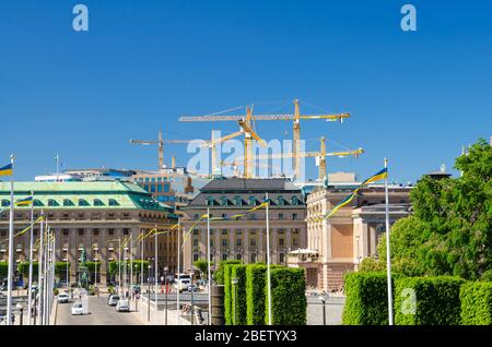 Riksplan, Büsche und Straße mit Nationalflaggen auf der Insel Sodermalm, Gustav Adolfs Torfplatz, Königlich Schwedische Oper Gebäude, blauer Himmel mit Schrei Stockfoto