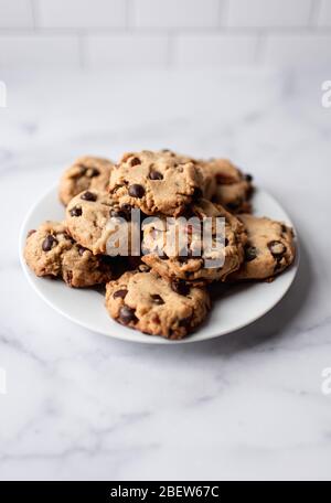 Nahaufnahme des Tellers der Chocolate Chip Cookies auf weißem Marmor Theke. Stockfoto