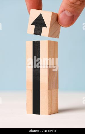 Erfolgreiches Geschäftskonzept - abstrakter schwarzer Pfeil auf Holzwürfeln. Nahaufnahme. Stockfoto
