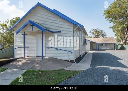 Die frisch gestrichene blau-weiß-vereinigende Kirche in Tea Gardens, New South Wales in Australien, ist aus Holzwitterungsbrett und einem Stahldach gebaut. Stockfoto