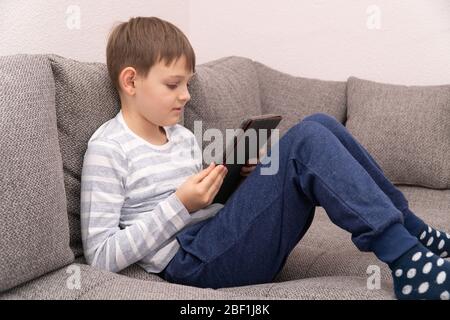 Fernunterricht Online-Bildung. Junge, die vor dem Tablet-pc denken, suchen. Stockfoto