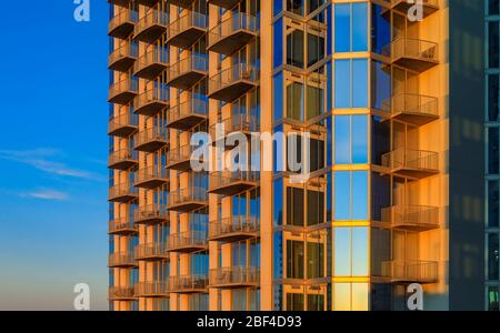 Blick auf das moderne neue Gebäude Wolkenkratzer Gebäude in der Innenstadt von Austin, Texas in der goldenen Stunde des Sonnenuntergangs, der Himmel spiegelt sich in den Fenstern Glas Stockfoto