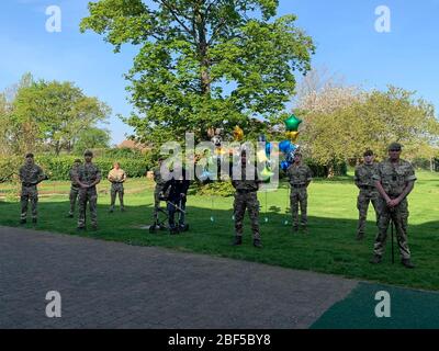 (200417) -- LONDON, 17. April 2020 (Xinhua) -- Tom Moore, ein pensionierter Beamter und Veteran des Zweiten Weltkriegs, steht mit Mitgliedern des 1. Bataillons, dem Yorkshire Regiment, nachdem er seine letzte Runde in seinem Garten in Bedfordshire, Großbritannien, am 16. April 2020 absolviert hatte. Der 99-jährige Kriegsveteran hat mehr als 12 Millionen Pfund (15 Millionen US-Dollar) für den National Health Service (NHS) durch die Durchführung von 100 Runden seines Gartens gesammelt. Mit Hilfe eines Gehrahmens hatte Tom Moore, ein pensionierter Beamter und Veteran des Zweiten Weltkriegs, geplant, 100 Runden seines Gartens in Bedfordshire zu drehen Stockfoto