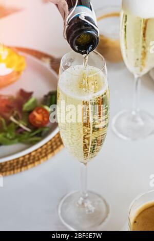 Am sonntagsbrunch Sekt in ein Glas gießen Stockfoto