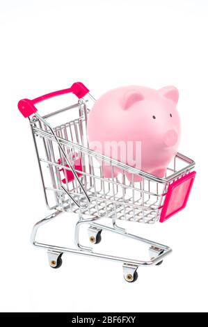 Kleines rosa Sparschwein ruht in Miniatur-Warenkorb auf weißem Hintergrund Stockfoto