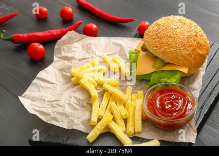 Leckerer Döner in Brötchen, Sauce und pommes frites auf dem Tisch Stockfoto