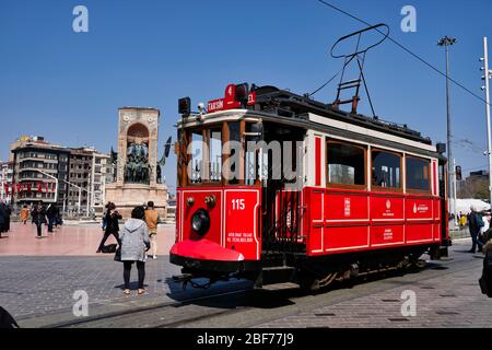 Nostalgische Rote Straßenbahn in der Taksim Istiklal Straße um 12 Uhr mittags. Die Taksim Istiklal Straße ist ein beliebtes Ziel in Istanbul. Beyoglu, Taksim, Istanbul. Türkei. Stockfoto