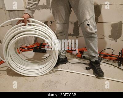 Fußbodenheizung ist auf einer Rohrleitung Installateur, Heizsystem und Fußbodenheizung montiert.2020 Stockfoto