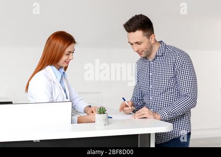 Assistentin mit Patient in der Klinik Stockfoto