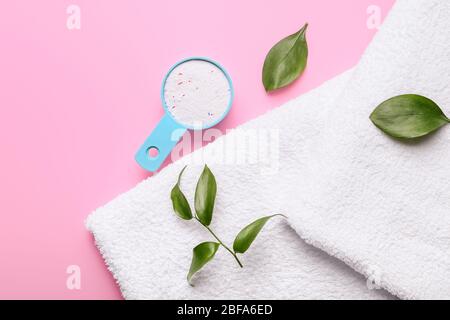 Handtücher und Waschmittel auf farbigem Hintergrund Stockfoto