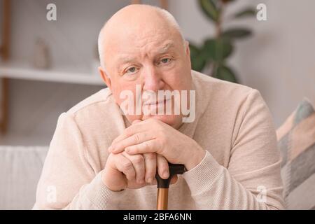 Älterer Mann, der zu Hause an geistiger Behinderung leidet Stockfoto