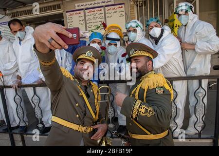 Der Offizier der iranischen Armee macht Selfie mit Krankenschwestern und Ärzten des Ali-Asghar Krankenhauses in Shiraz, Iran, nach der Feier des Nationalfeiertags der iranischen Armee. Sie haben auch Musik gespielt und die Bemühungen des medizinischen Personals geschätzt. Iran, Provinz Fars, Shiraz. April 2020. Stockfoto