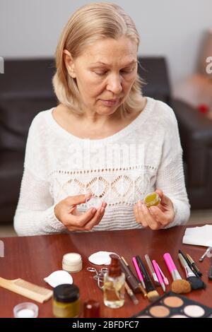 Perfekt, hübsch, Frau, die Augencreme, hält Glas kosmetischen Produkt Stockfoto