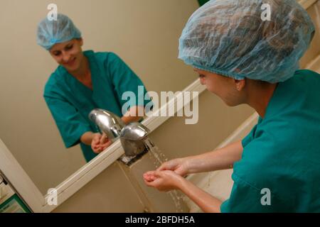 Chirurg wäscht ihre Hände vor der Operation Stockfoto