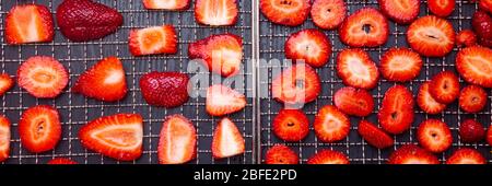 In Scheiben geschnittene reife Erdbeeren in Trockentabletts auf Holzhintergrund, frische Beeren Makro. Gesunde Snacks (Chips) , Mahlzeit, Draufsicht, Ansicht von oben Stockfoto