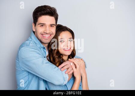 Portrait of positive fröhlich leidenschaftliche Ehegatten Umarmung Genießen Sie zusammen Freizeit Lifestyle tragen lässigen Stil Kleidung über graue Farbe isoliert Stockfoto