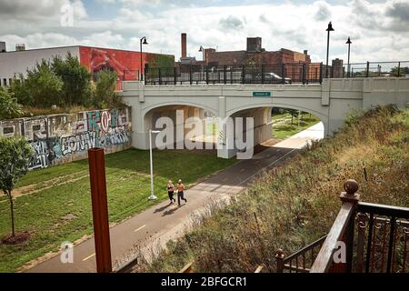 Eineineinleins junges Paar joggt auf dem Dequindre Cut Greenway in der Eastern Market Gegend in Downtown Detroit, Michigan USA Stockfoto