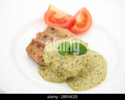 London, 2020, gebratene Thunfischsteak serviert mit EINER cremigen Basilikum-Pesto-Sauce, frischer Minze und Bio-Tomaten. Stockfoto