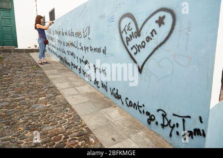 Fotografin fotografiert Straßenliedlosungen an einer Wand in Santa Cruz de La Palma Downtown (La Palma, Kanarische Inseln, Atlantik, Spanien) Stockfoto