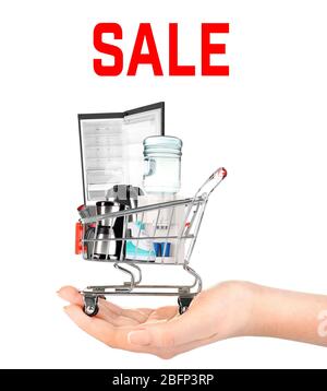 Online-Shopping-Konzept, Einkaufswagen mit Haushaltsgeräten zur Hand, isoliert auf weiß Stockfoto