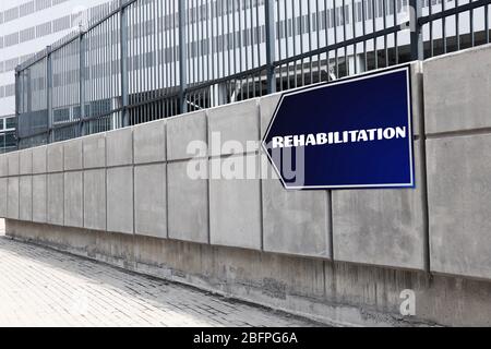 Recovery-Konzept. Schild mit Wort REHABILITATION an Wand im Freien Stockfoto