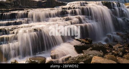 Schöner Wasserfall im Fluss fließt ein glattes Wasser Stockfoto