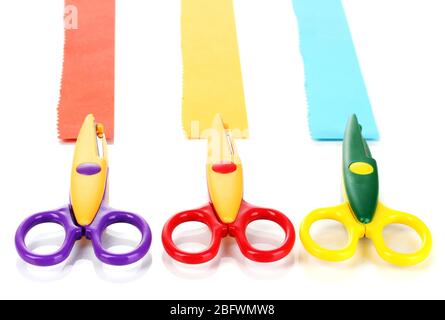 Bunte Zickzack-Schere mit Papierstreifen isoliert auf weiß Stockfoto