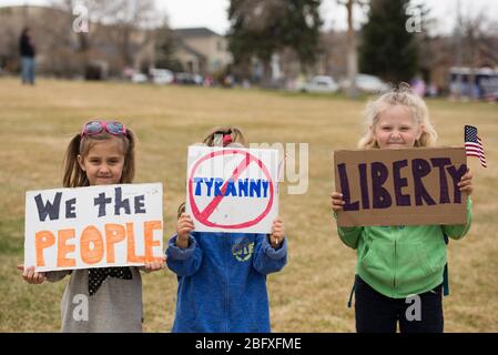 Helena, Montana - 19. April 2020: Kinder, junge Mädchen, die Freiheit und Tyrannei unterschreiben auf der Protestkundgebung im Capitol aufgrund der Regierung sh Stockfoto