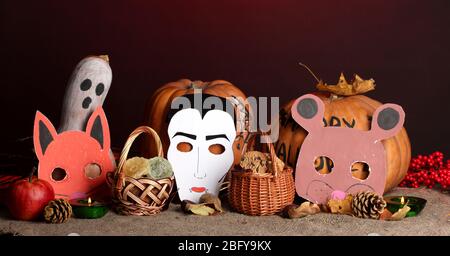 Trick or Treat halloween Masken und Eimer gefüllt mit Cookies auf farbigen Hintergrund Stockfoto